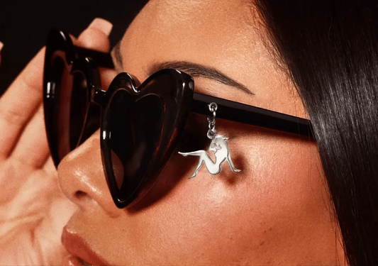 Black heart sunglasses worn with silver Beyoncé silhouette charm detail on side