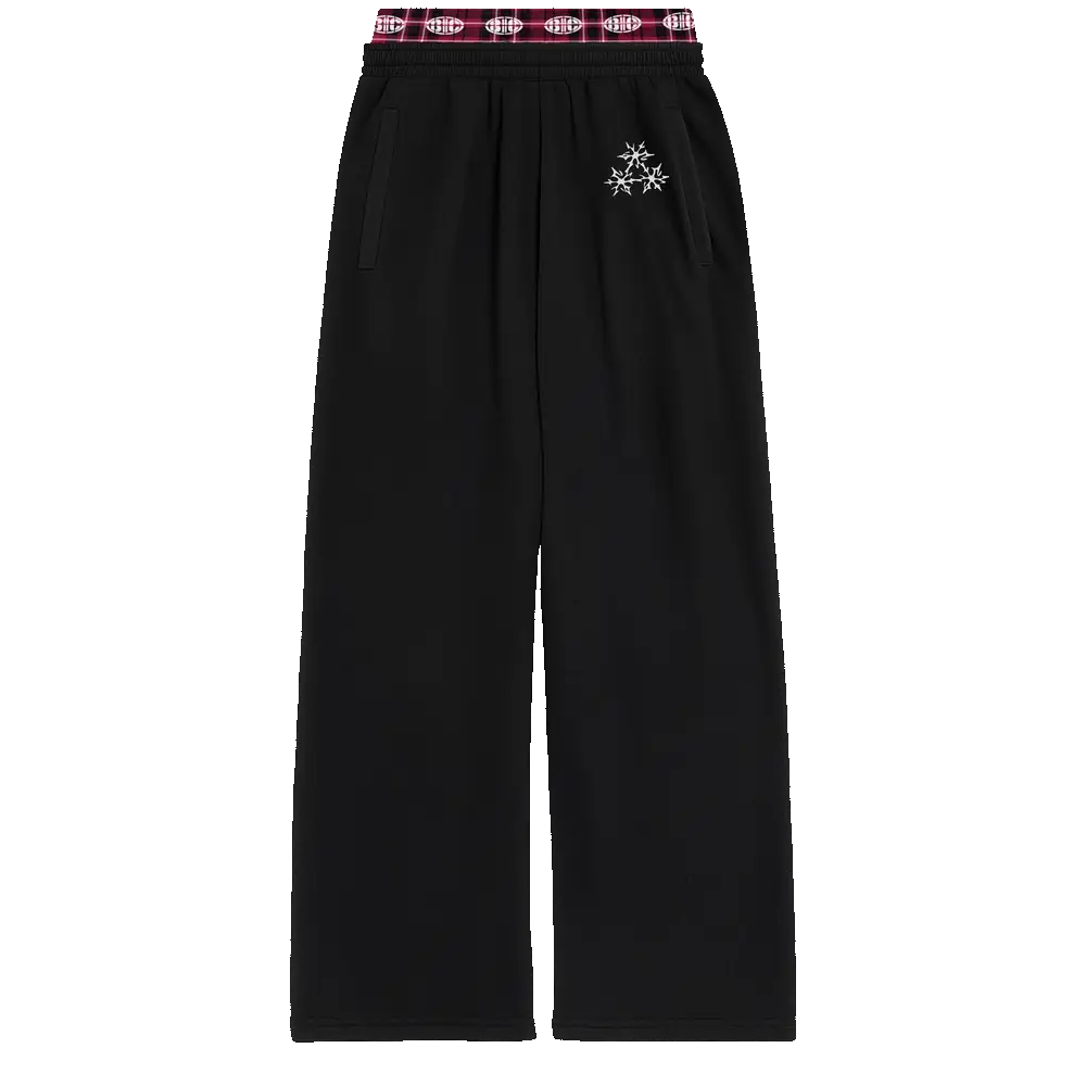 Black sweatpants with red plaid waistband and small star graphic detail on upper leg