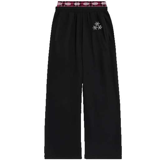 Black sweatpants with red plaid waistband and small star graphic detail on upper leg