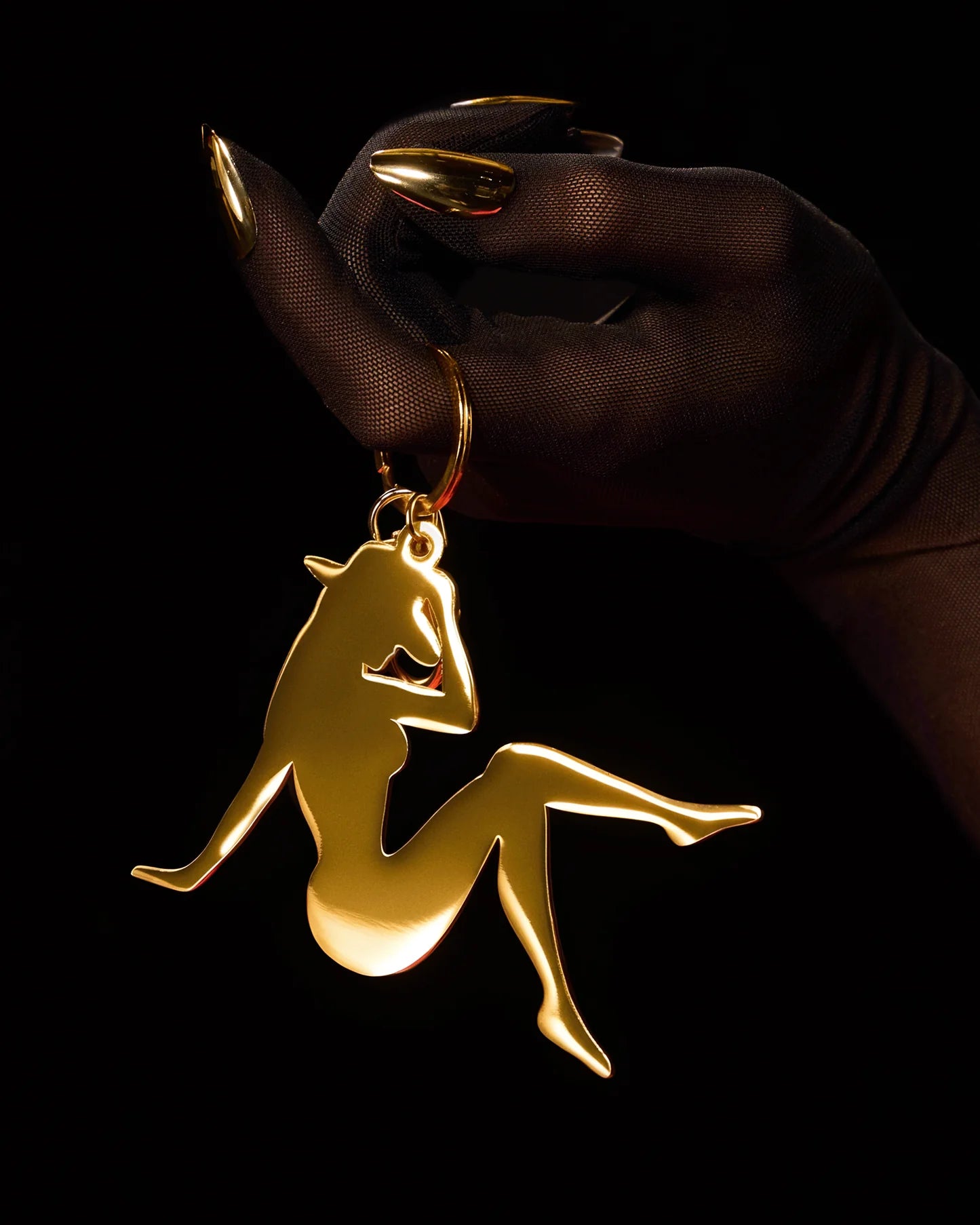 Gold Lady Bey silhouette charm keychain held in hand with black glove