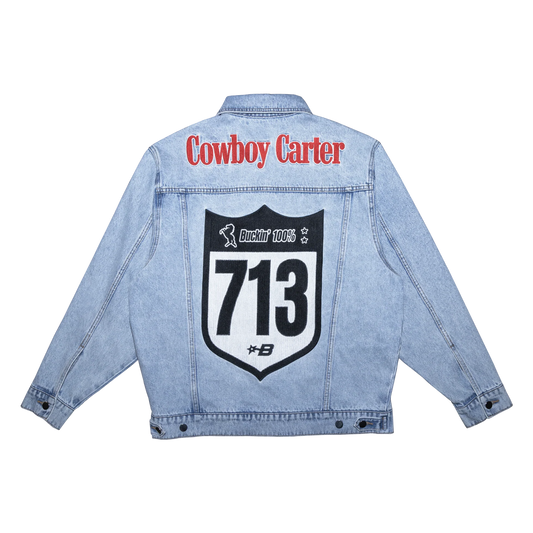 Light blue denim jacket with bold Cowboy Carter text and large 713 graphic patch on back