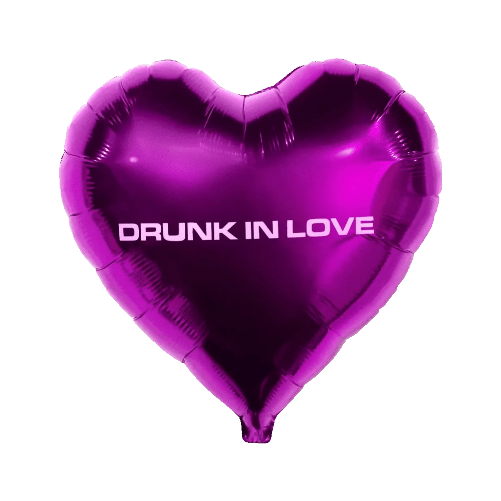 Purple heart-shaped foil balloon with “drunk in love” text