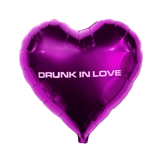 Purple heart-shaped foil balloon with “drunk in love” text