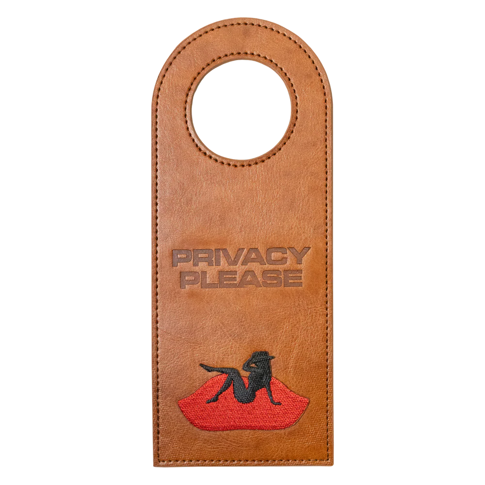 Brown leather door tag with Privacy Please text and Beyoncé silhouette graphic on red lips